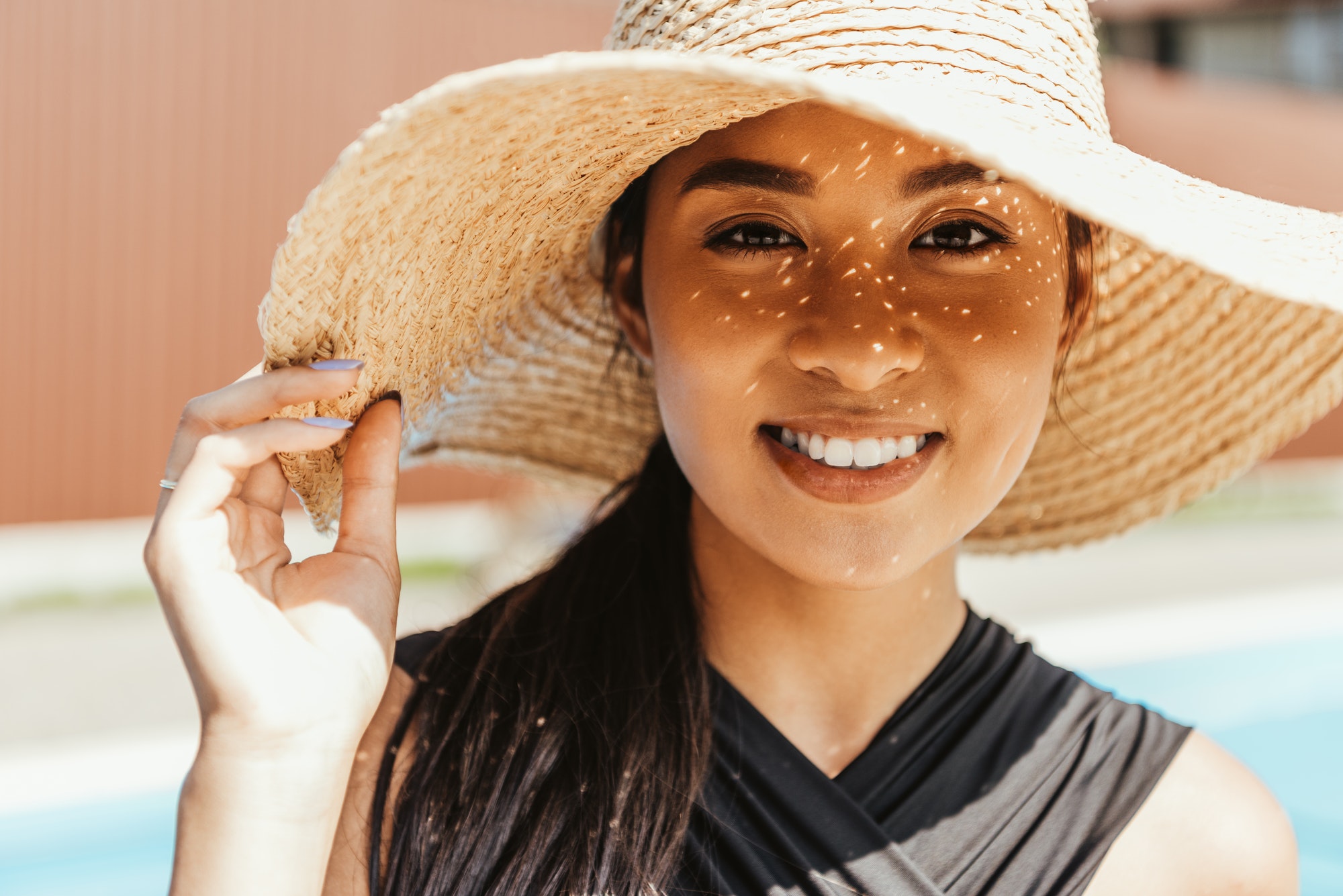 happy asian girl in swimsuit and straw hat